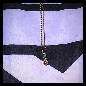 Gold necklace with a cute emerald gem